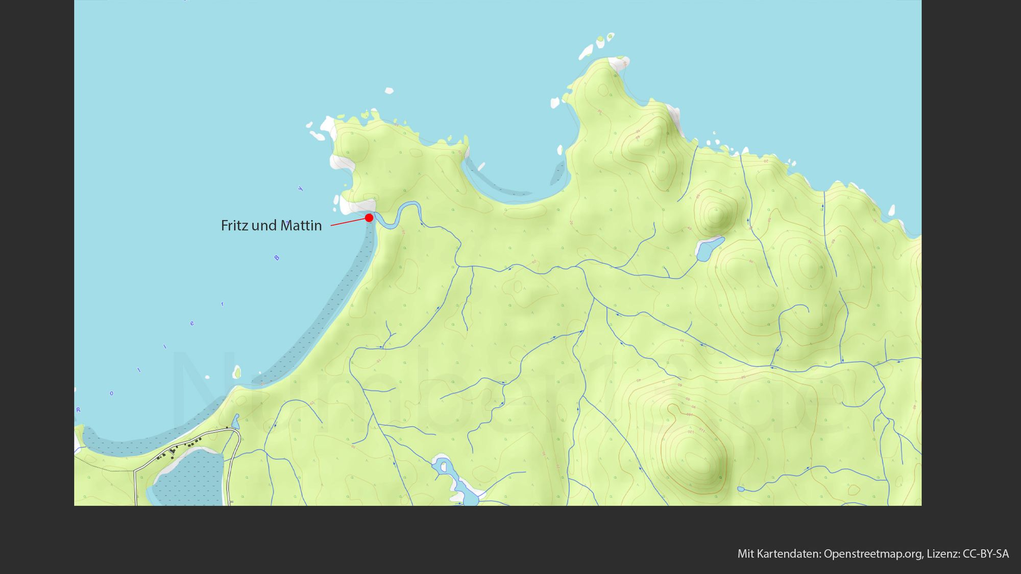 Topografische Karte, die eine Küstenregion mit einer Mischung aus Land und Meer zeigt. Die Landmassen sind in gelben und grünen Farbtönen gehalten, was Höhenunterschiede anzeigt. Ein roter Punkt mit einem Pfeil ist beschriftet mit "Fritz und Mattin" und liegt nahe der Küstenlinie, die mit einer blauen Farbe markiert ist. Mehrere blaue Linien schlängeln sich durch die Landschaft, was auf Flüsse oder Bäche hindeutet. In der unteren Ecke ist ein Hinweis auf die Quelle der Karte: "Mit Kartendaten: Openstreetmap.org, Lizenz: CC-BY-SA"